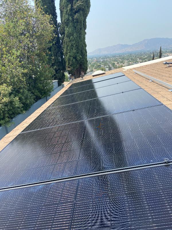 Stack of solar panels leaning against a wall