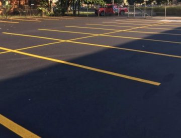 An asphalt parking lot newly striped