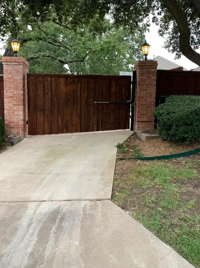 Fence providing driveway with privacy.