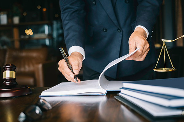 Man in a suit signing papers