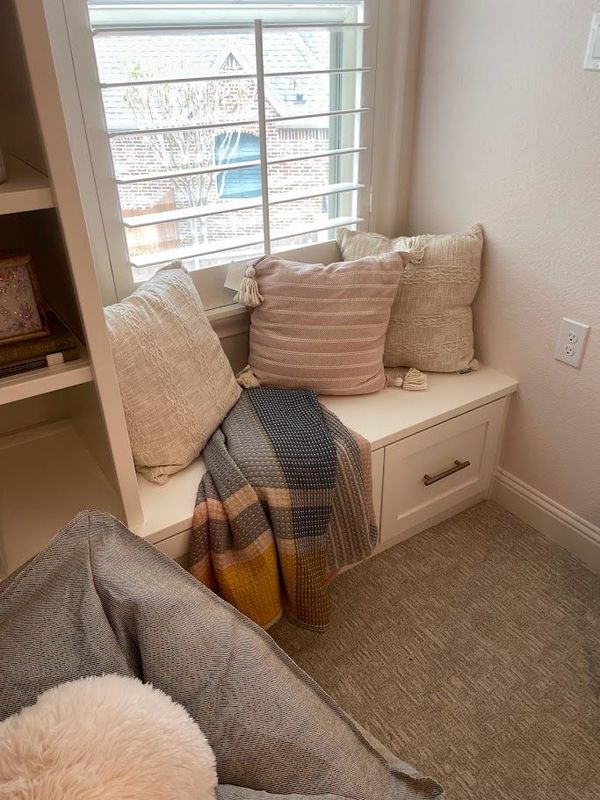 nook area in room with pillows and blanket