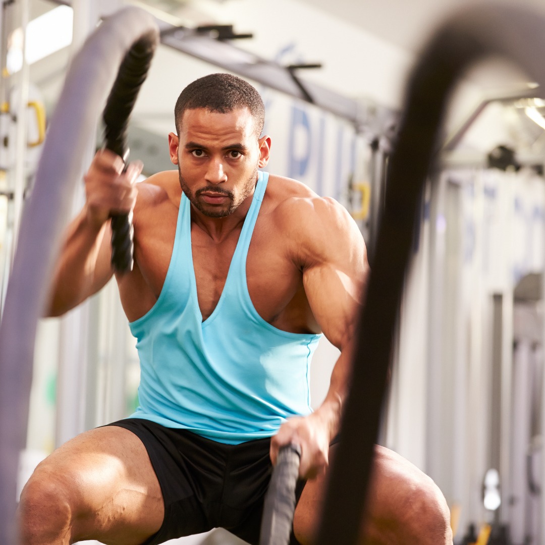 man using ropes to workout