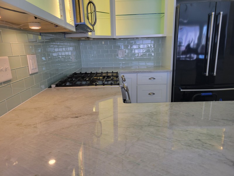 A kitchen area with marble countertops.