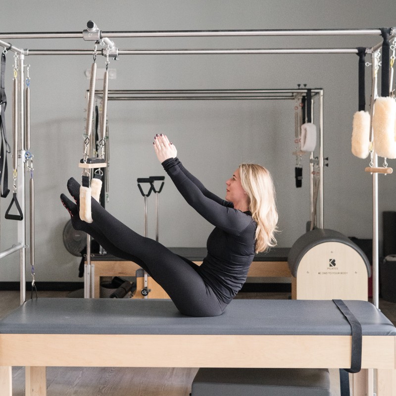 Woman posing on Pilates equipment