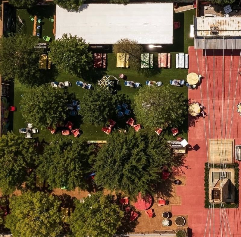 Aerial shot of the vendor market, red brick thoroughfare surrounded by grass and trees