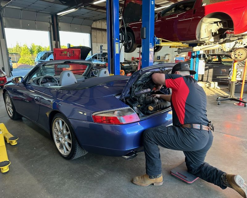 A mechanic is working on a car