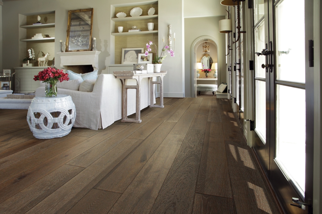 A living room and hallway features dark laminate flooring,