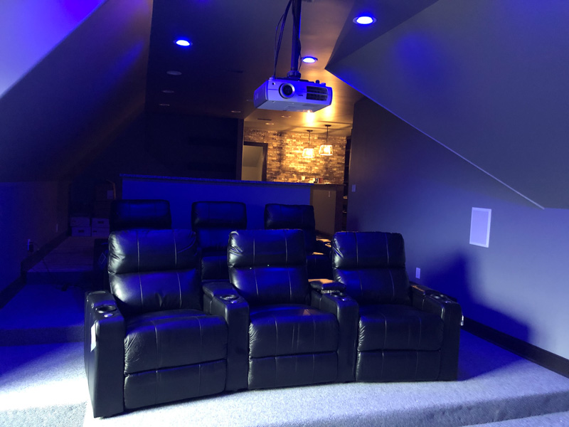 Home theater room with dimming lights.