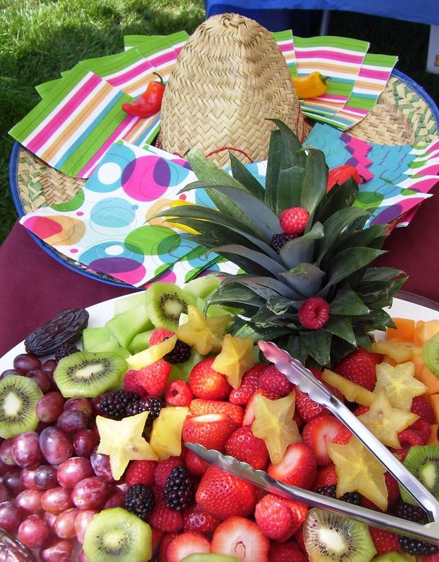 presentation plate full of fruit next to a hat