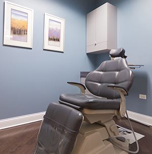 dental exam chair, black, blue walls with art