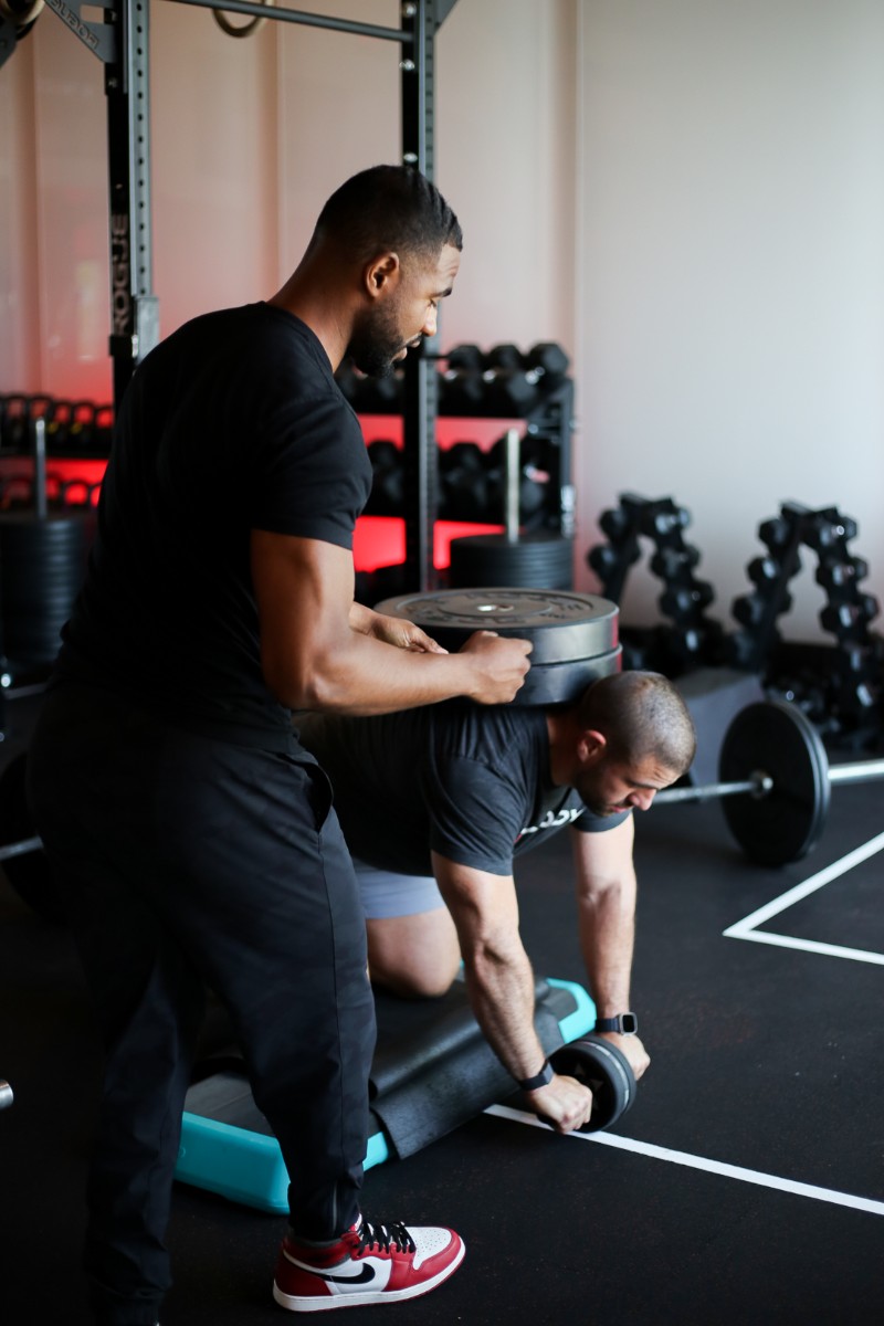 Two RevBody trainers smiling and laughing together.