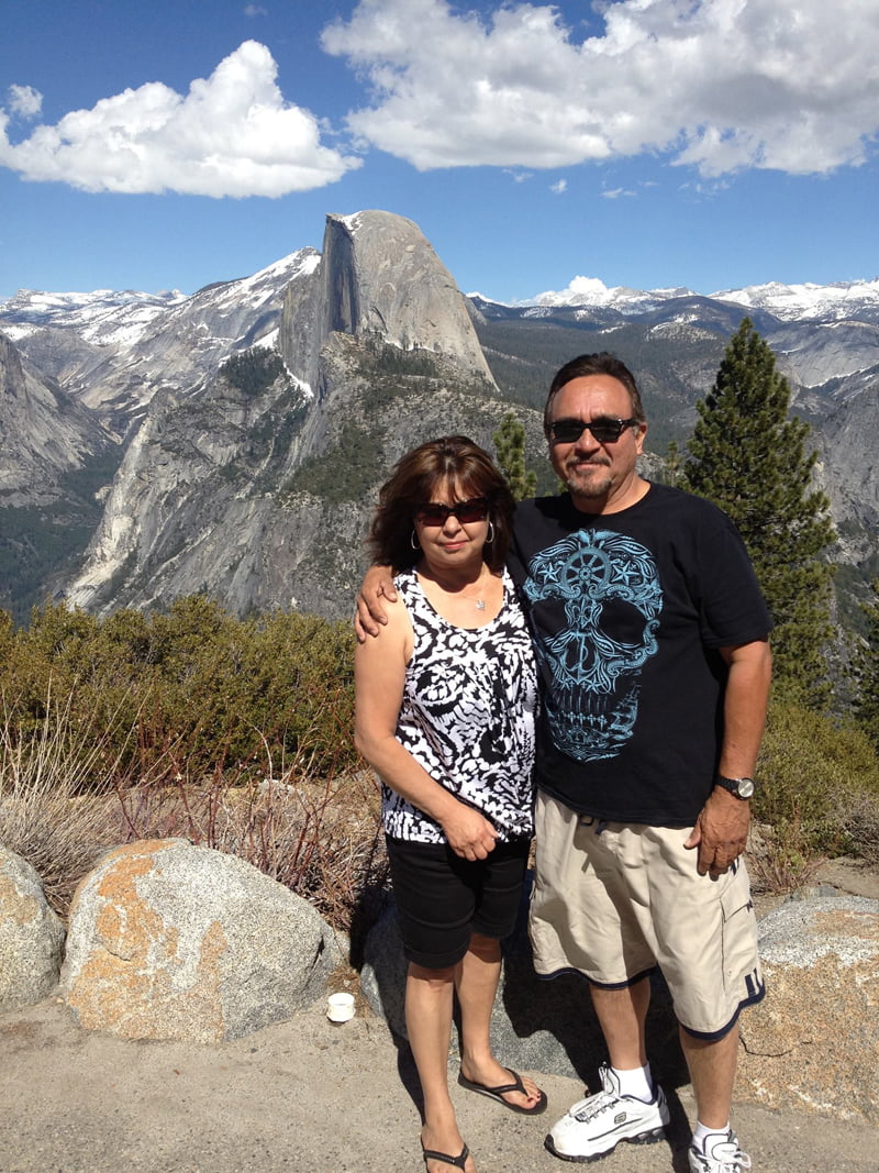 Pete and Cindy Hernandez with a picturesque mountain range behind them.