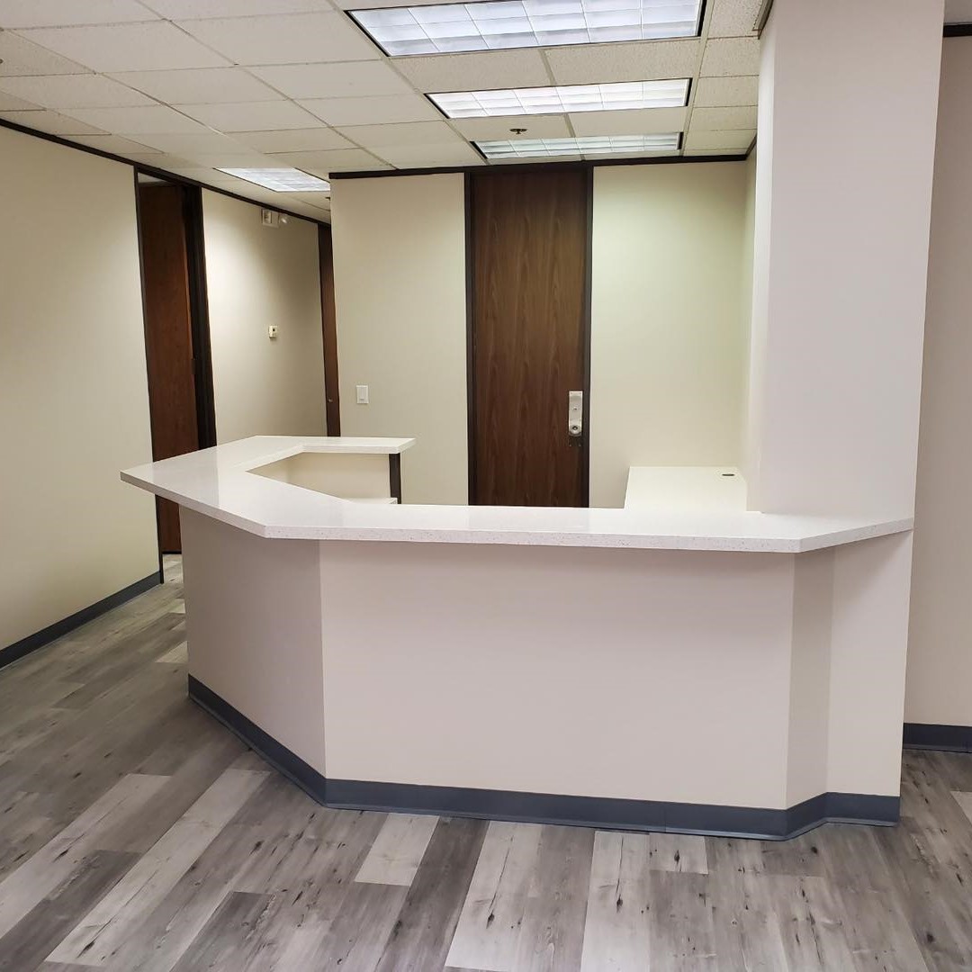 Front desk of an office with gray LVP flooring.